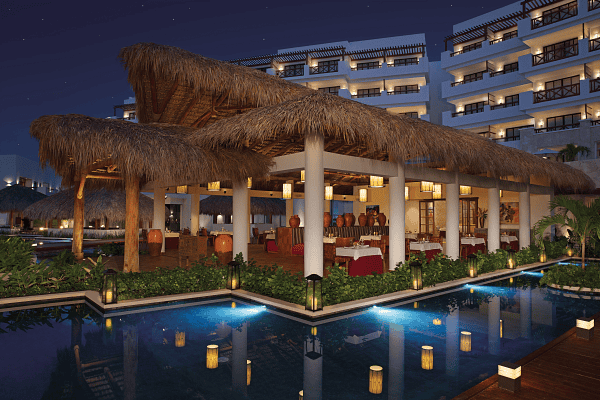 Hotel at night showing pool and hotel